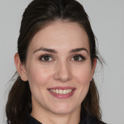 Joyful white young-adult female with medium  brown hair and brown eyes