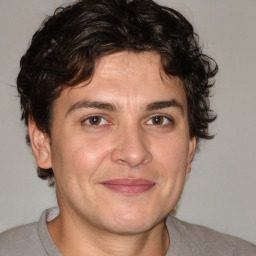 Joyful white adult male with medium  brown hair and brown eyes