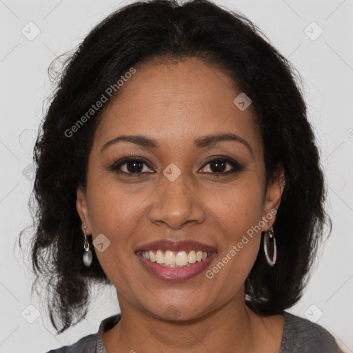 Joyful black adult female with medium  brown hair and brown eyes