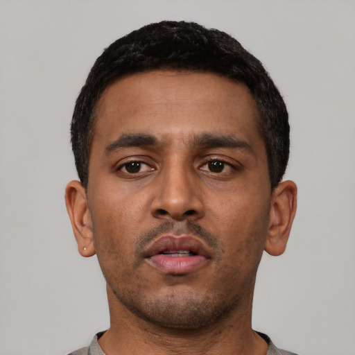 Neutral latino young-adult male with short  black hair and brown eyes