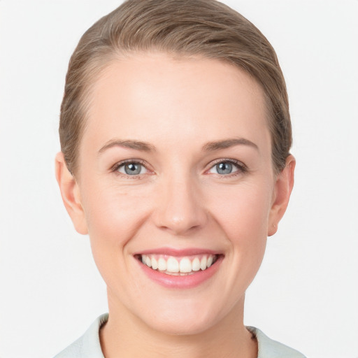 Joyful white young-adult female with short  brown hair and grey eyes