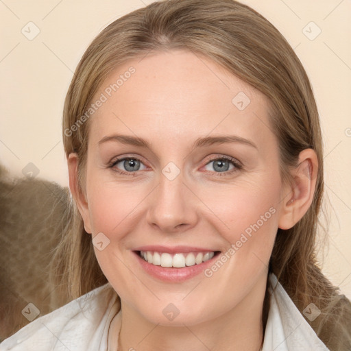 Joyful white young-adult female with medium  brown hair and blue eyes