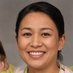 Joyful white adult female with medium  brown hair and brown eyes