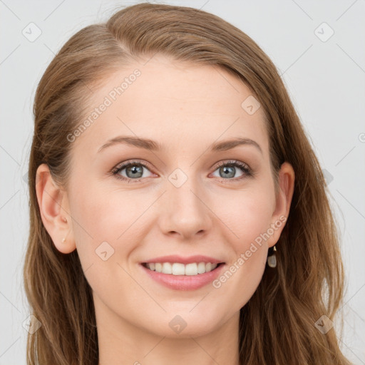 Joyful white young-adult female with long  brown hair and blue eyes