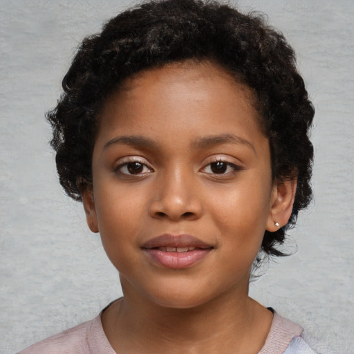 Joyful black child female with short  black hair and brown eyes