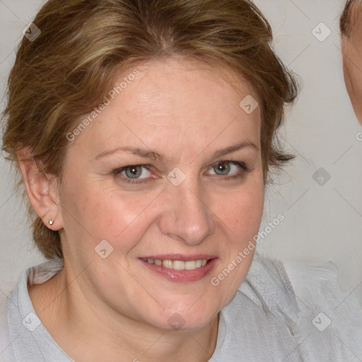 Joyful white adult female with medium  brown hair and blue eyes