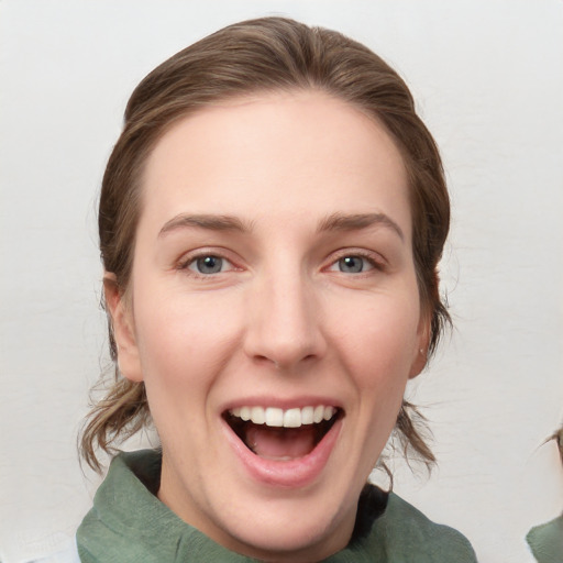 Joyful white young-adult female with medium  brown hair and grey eyes