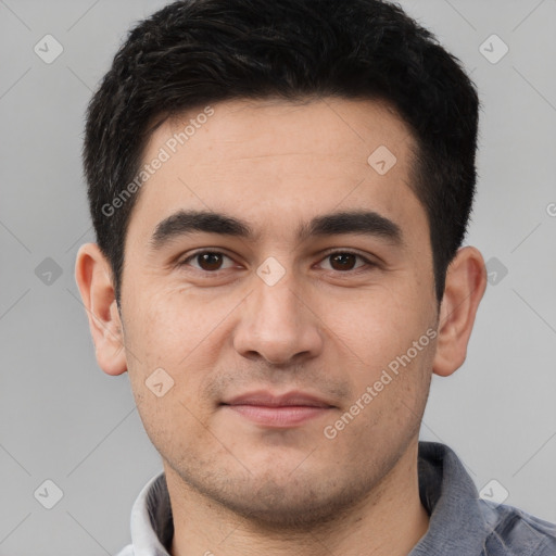 Joyful white young-adult male with short  black hair and brown eyes