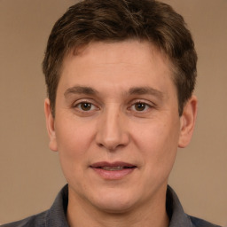 Joyful white adult male with short  brown hair and brown eyes