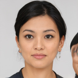 Joyful asian young-adult female with medium  black hair and brown eyes