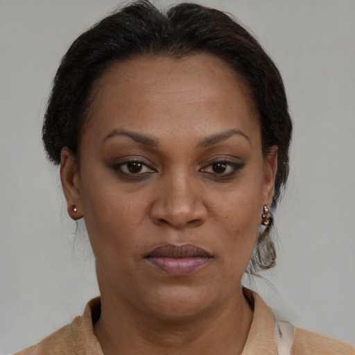 Joyful black adult female with short  brown hair and brown eyes