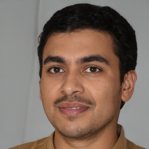 Joyful latino young-adult male with short  black hair and brown eyes