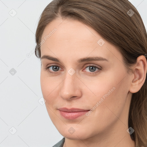 Joyful white young-adult female with long  brown hair and grey eyes