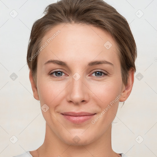 Joyful white young-adult female with short  brown hair and grey eyes