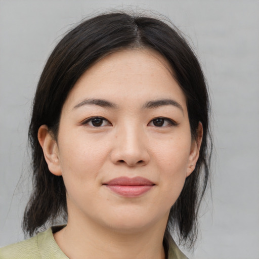 Joyful asian young-adult female with medium  brown hair and brown eyes