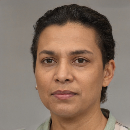 Joyful latino adult female with short  brown hair and brown eyes