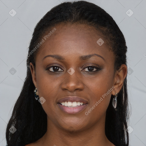 Joyful black young-adult female with long  brown hair and brown eyes