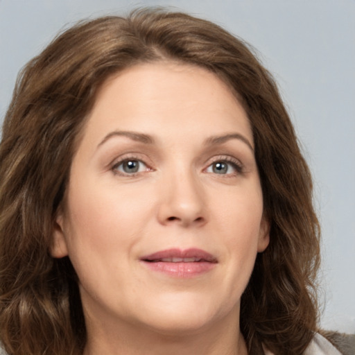 Joyful white young-adult female with medium  brown hair and green eyes