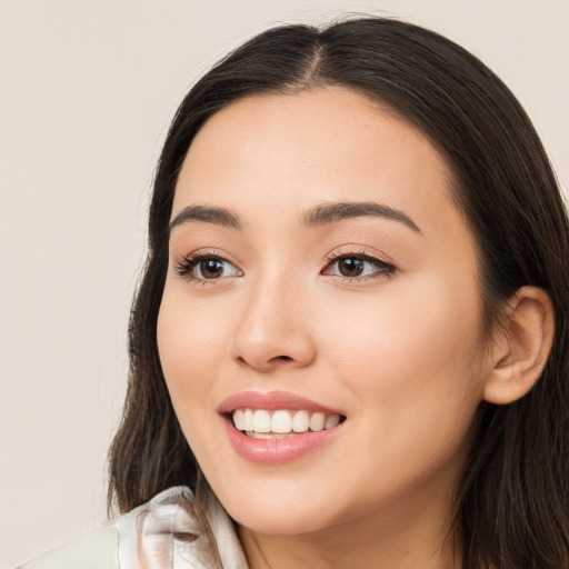 Joyful white young-adult female with long  black hair and brown eyes