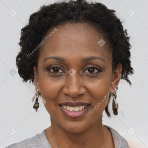 Joyful black adult female with short  brown hair and brown eyes