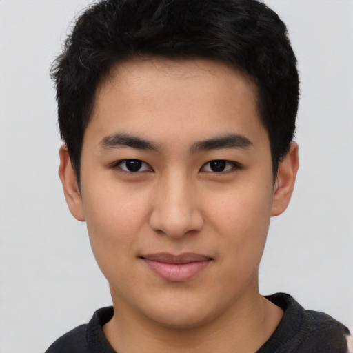 Joyful asian young-adult male with short  black hair and brown eyes