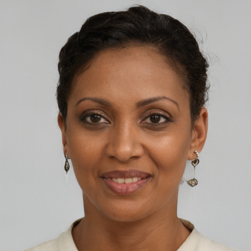Joyful black young-adult female with short  brown hair and brown eyes