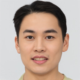 Joyful asian young-adult male with short  black hair and brown eyes