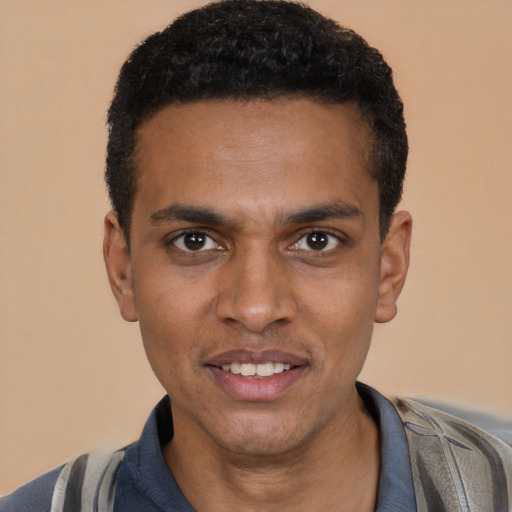 Joyful black young-adult male with short  black hair and brown eyes