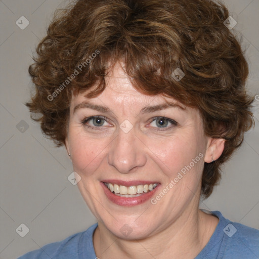 Joyful white adult female with medium  brown hair and blue eyes