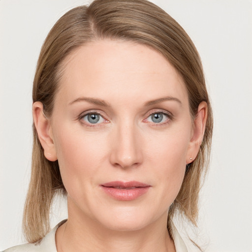 Joyful white young-adult female with medium  brown hair and blue eyes