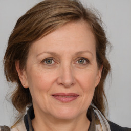 Joyful white adult female with medium  brown hair and grey eyes