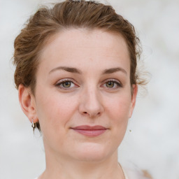 Joyful white young-adult female with medium  brown hair and green eyes