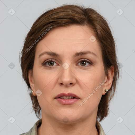 Joyful white adult female with medium  brown hair and grey eyes