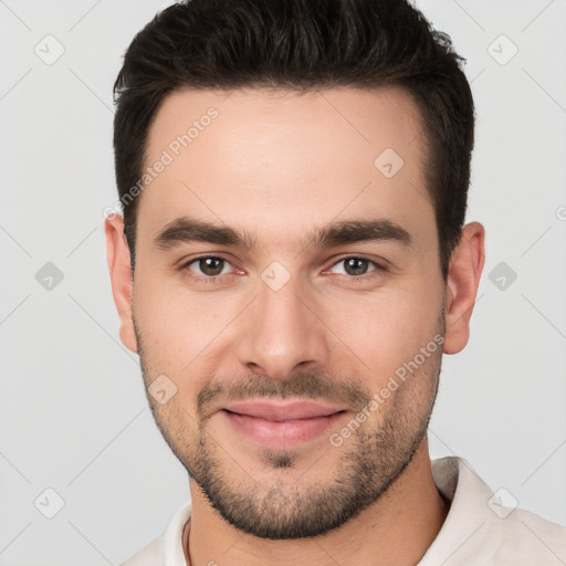 Joyful white young-adult male with short  brown hair and brown eyes