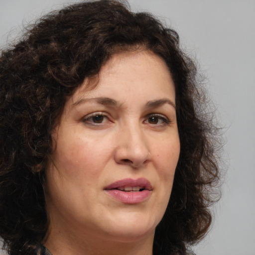 Joyful white adult female with long  brown hair and brown eyes