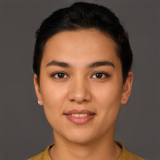 Joyful latino young-adult female with short  brown hair and brown eyes