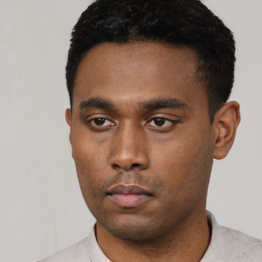 Neutral latino young-adult male with short  black hair and brown eyes