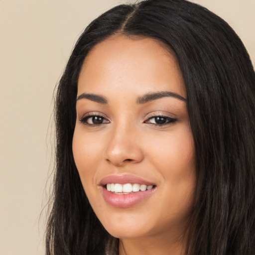 Joyful latino young-adult female with long  black hair and brown eyes