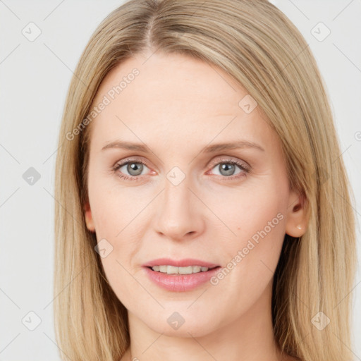 Joyful white young-adult female with long  brown hair and blue eyes