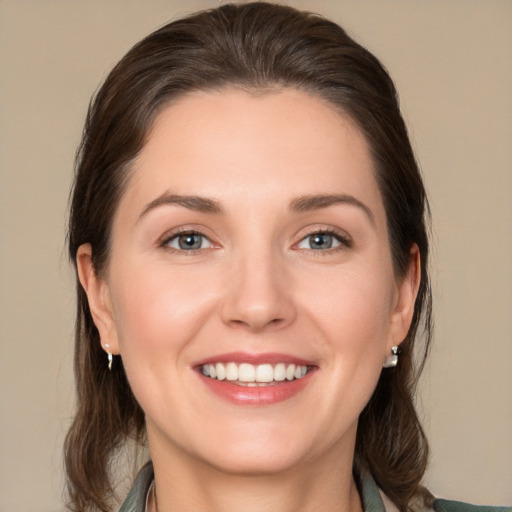 Joyful white young-adult female with medium  brown hair and brown eyes