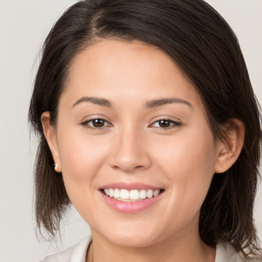 Joyful white young-adult female with medium  brown hair and brown eyes