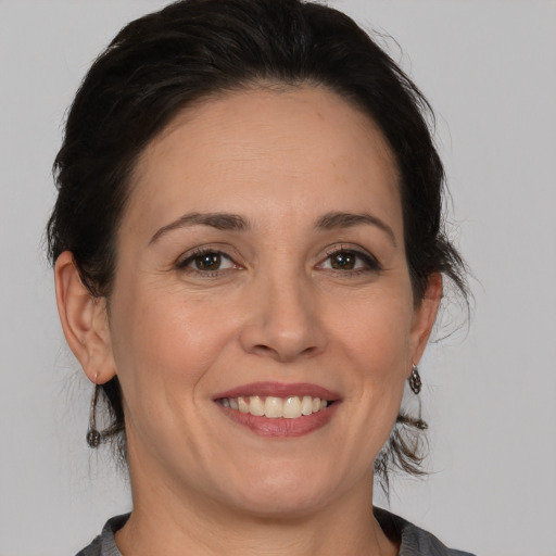 Joyful white adult female with medium  brown hair and brown eyes