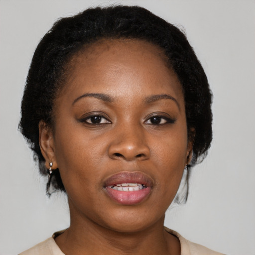 Joyful black young-adult female with medium  black hair and brown eyes