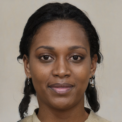 Joyful black young-adult female with medium  black hair and brown eyes