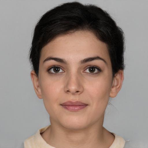 Joyful white young-adult female with short  brown hair and brown eyes