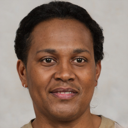 Joyful latino adult male with short  brown hair and brown eyes