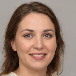 Joyful white young-adult female with medium  brown hair and brown eyes