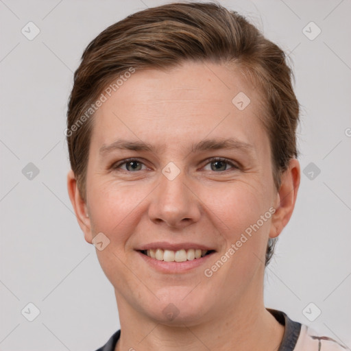 Joyful white young-adult female with short  brown hair and grey eyes