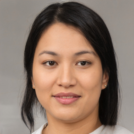 Joyful asian young-adult female with medium  brown hair and brown eyes