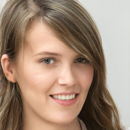 Joyful white young-adult female with long  brown hair and blue eyes